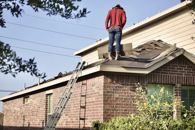 Professional roofer working on a residential roof in Brockway Landing